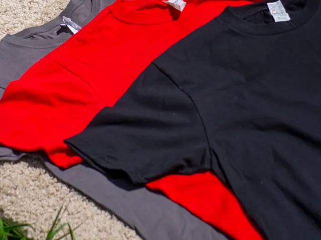 Colourful knit t-shirts laid on grass