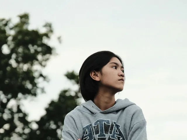 Person wearing a knit hoodie outdoors