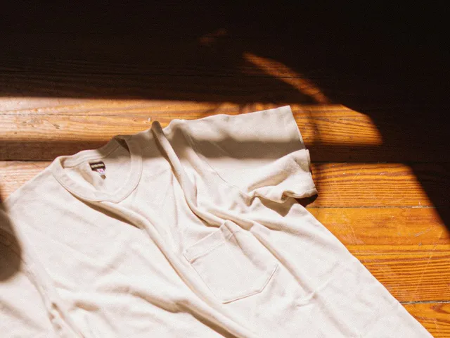 White knit t-shirt on a wooden floor in sunlight