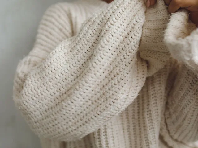 Cozy beige knitted sweater close-up