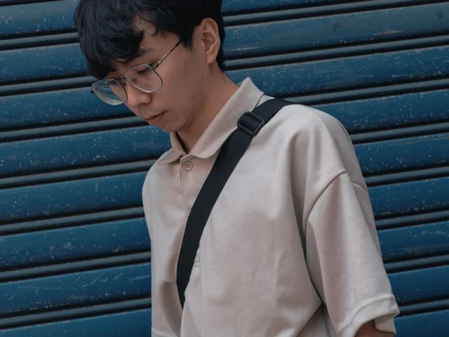 Man wearing glasses and a knitted polo shirt
