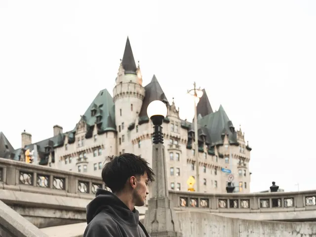 Young man in a hoodie by a historic landmark