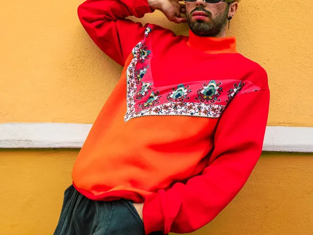 Man posing in a knit sweatshirt