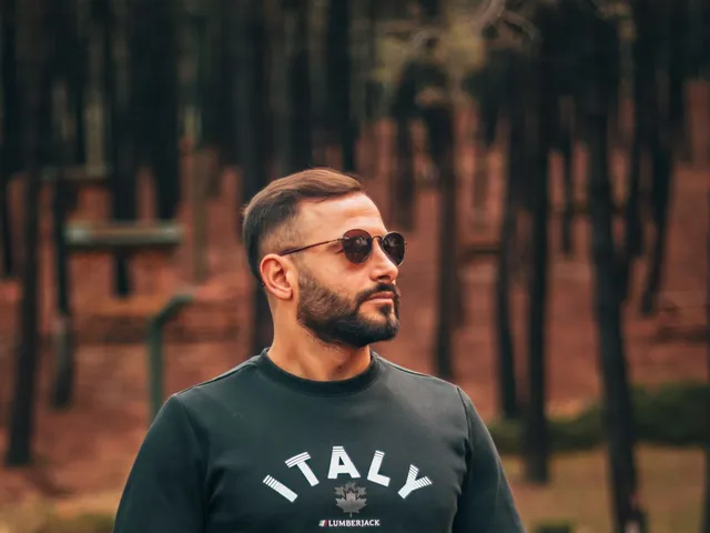 Model in a black printed sweatshirt and jeans