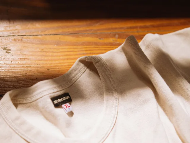 Minimalist fashion flat lay of a white t-shirt