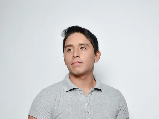 Young man in a knitted polo shirt in studio