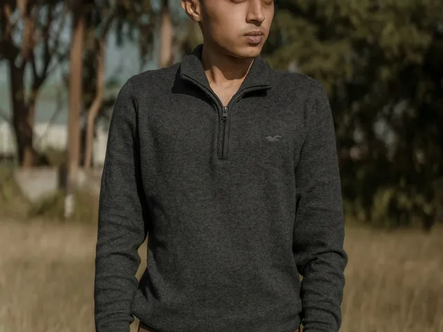 Model in a knitted polo sweater in a clearing