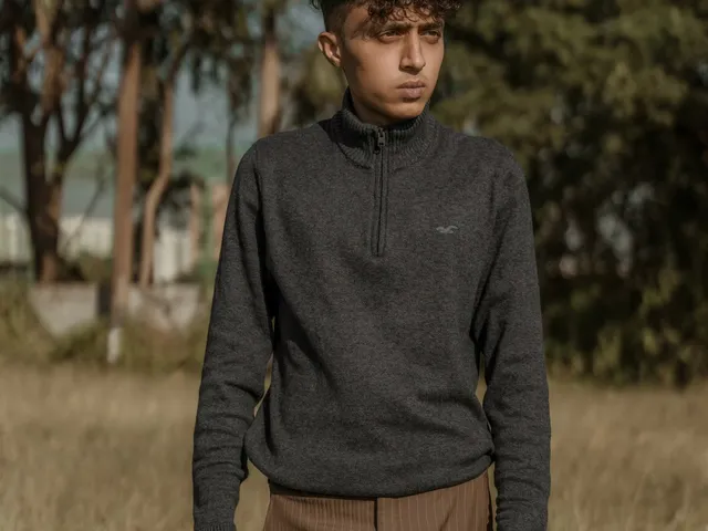 Model walking in a grey zipper sweater