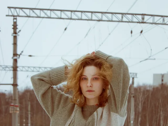 Young woman in a knitted sweater outside in winter